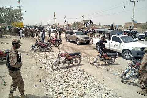 Security officers gather at the site of a blast outside a polling station in Quetta, Pakistan (Reuters)