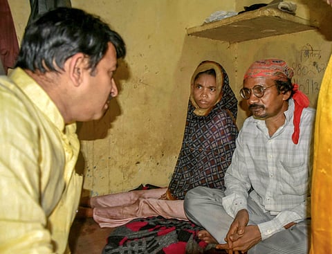 Delhi BJP President Manoj Tiwari meets the mother and a relative of the three girls who died allegedly of starvation in Mandawali area in New Delhi on Thursday July 26 2018. | PTI