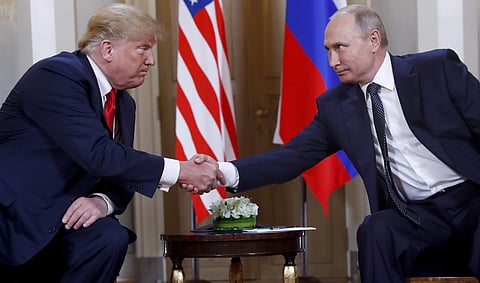 U.S. President Donald Trump, left, and Russian President Vladimir Putin shake hands. (Photo | AP)