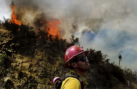 A firefighter watches as the Cranston fire grows to more 1,200 acres in the San Bernardino National Forest. (Photo | AP)
