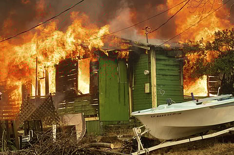 A structure burns as the Carr Fire tears through Shasta, Calif., Thursday, July 26, 2018. Fueled by high temperatures, wind and low humidity, the blaze destroyed multiple homes and at least one historic building. (Photo | AP)