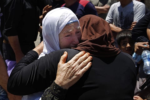 Syrian refugees prepare to cross into Syria by bus at the Lebanese border crossing point of Masnaa, in Bekaa Valley, Lebanon. (Photo | AP)