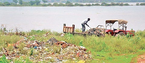 A man dumping garbage on Mahanadi bank near Gadagadia Ghat in Cuttack 
