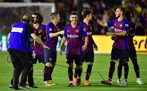 Barcelona's players celebrate after Malcolm scored the match winning penalty during the International Champions Cup football match between Barcelona and Tottenham Hotspur. | AFP