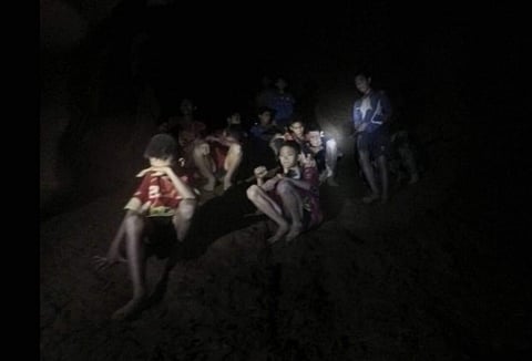 This Monday, July 2, 2018, photo released by Tham Luang Rescue Operation Center, shows the boys and their soccer coach as they were found in a partially flooded cave, in Mae Sai, Chiang Rai, Thailand. The 12 boys and coach found after 10 days are mostly i