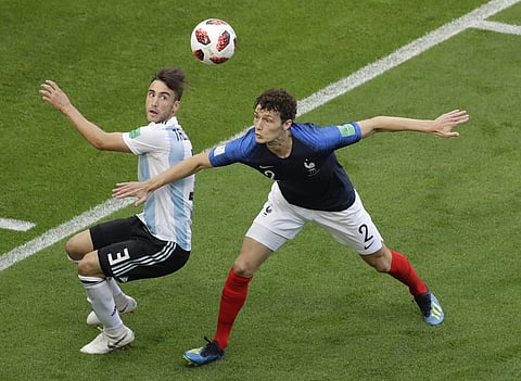 Argentina's Nicolas Tagliafico, left, and France's Benjamin Pavard challenge for the ball during the round of 16 match between France and Argentina, at the 2018 soccer World Cup at the Kazan Arena in Kazan. | AP