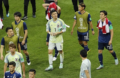 Japan's players leave the pitch at the end of the round of 16 match between Belgium and Japan at the 2018 soccer World Cup in the Rostov Arena, in Rostov-on-Don, Russia, Monday, July 2, 2018. | AP