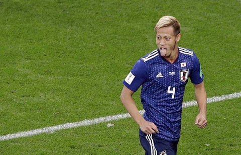 Japan's Keisuke Honda celebrates after scoring his site's second goal during the group H match between Japan and Senegal at the 2018 soccer World Cup at the Yekaterinburg Arena. | AP