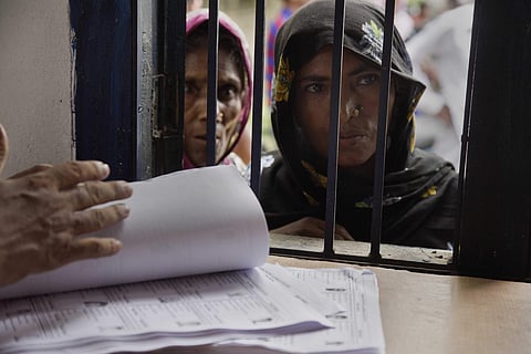 In the final draft released, the list of India's citizens in Assam, around 4 million people were not featured, leaving them on edge to prove their Indian nationality. In this image: Muslim women stand in a queue to check if their names are included in the
