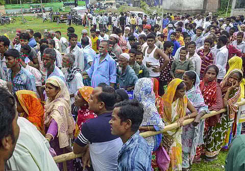 People wait to check their names on the final draft of the state's National Register of Citizens after it was released at an NRC Seva Kendra in Tezpur on Monday July 30 2018. (Photo: PTI)