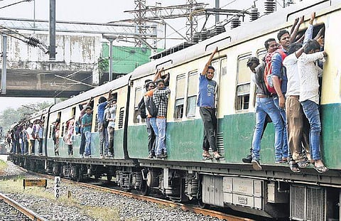 The footboard travellers in a suburban train. The Southern Railway has decided to cancel the railway passes and season tickets of such passengers | ASHWIN PRASATH