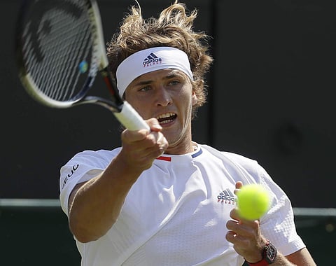 Alexander Zverev returns a ball to James Duckworth during their men's singles match on the second day at the Wimbledon Tennis Championships in London. | AP