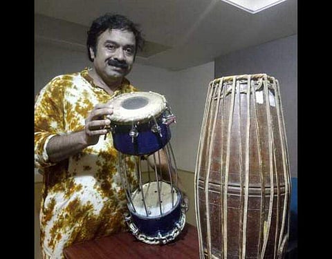 Mridangam maestro Kuzhalmannam Ramakrishnan displaying the traditional mridangam and also the newly created light weight mridangam for which he has received a patent. | EPS