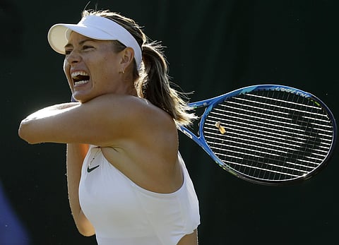 Maria Sharapova returns a ball to Vitalia Diatchenko during their women's singles match on the second day at the Wimbledon Tennis Championships in London. | AP