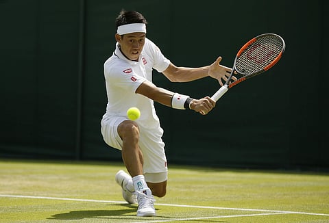 Kei Nishikori of Japan returns the ball to Christian Harrison of the US during their men's singles match on the second day at the Wimbledon Tennis Championships in London, Tuesday July 3, 2018.  | AP