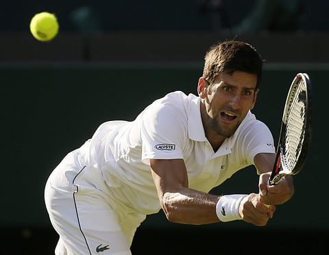 Novak Djokovic returns a ball to Tennys Sandgren during their men's singles match on the second day at the Wimbledon Tennis Championships in London. | AP