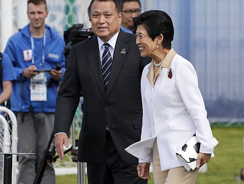 Japan's Princess Takamado is escorted by Japan Football Association President Kozo Tashima, left, to the training fieldprior to a training session of Japan national team