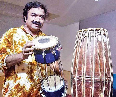 Kuzhalmannam Ramakrishnan with his traditional and new mridangam