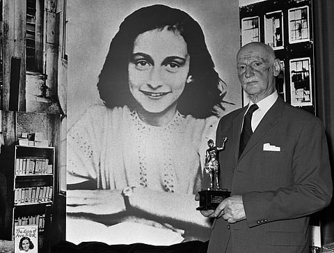 In this Monday, June 14, 1971 photo Dr. Otto Frank holds the Golden Pan award, given for the sale of one million copies of the famous paperback 'The Diary of Anne Frank' in London, Great Britain. New research suggests that the family of Anne Frank, the wo