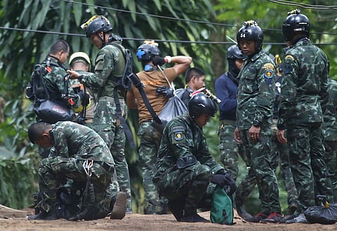 Thai rescuers prepare to enter the cave where 12 boys and their soccer coach have been trapped since June 23, in Mae Sai, Chiang Rai province, in northern Thailand Friday, July 6, 2018. Thai authorities are racing to pump out water from the flooded cave b