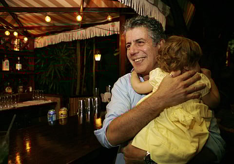 In this Nov. 12, 2008 file photo, Chef Anthony Bourdain holds his daughter Ariane in Miami Beach. Court papers show that Bourdain was worth $1.2 million when he died last month. (Photo | AP)