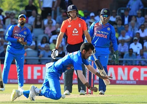 England's Jos Buttler (C) looks on as India's Yuzvendra Chahal (front) drops a catch off his hit during the second T20 match between England and India at Old Trafford cricket ground in Manchester, northwest England, on July 3, 2018. | AFP