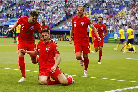 England's Harry Maguire celebrates with his teammates after scoring his side opening goal during the quarterfinal match between Sweden and England at the 2018 soccer World Cup in the Samara Arena, in Samara, Russia. | AP