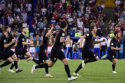 Croatia's players celebrate winning the penalty shootout during the Russia 2018 World Cup quarter-final football match between Russia and Croatia at the Fisht Stadium in Sochi. | AFP