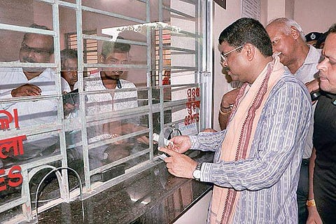 Union Minister Dharmendra Pradhan buying ticket at Bhubaneswar New railway station at Barang after inaugurating it on Saturday | Express
