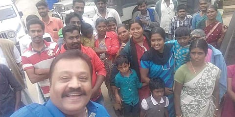 Rajya Sabha MP Suresh Gopi takes a selfie with local residents and BJP workers after visting slain SFI leader Abhimanyu’s house in Vattavada on Saturday | Express