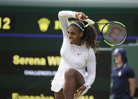 Serena Williams of the United States returns the ball to Russia's Evgeniya Rodina during their women's singles match, on day seven of the Wimbledon Tennis Championships, in London. (AP)