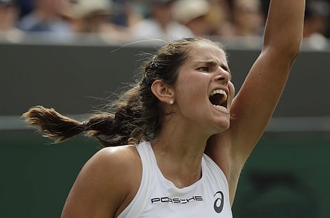 Julia Goerges of Germany celebrates winning a point from Donna Vekic of Croatia during their women's singles match on the seventh day at the Wimbledon Tennis Championships in London. (AP)