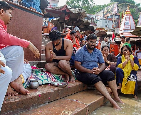 Relatives immerse ashes of the family members who committed suicide in Burari at a ghat of river Ganga in Haridwar on Monday July 09 2018. | PTI