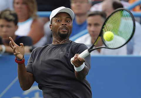 Donald Young returns against Stan Wawrinka of Switzerland during the first round of the Citi Open tennis tournament. | AP