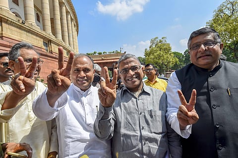 Deputy Chairman of Rajya Sabha Harivansh Singh flashes the victory sign with Union minister Ravi Shanker Prasad and others Parliament House in New Delhi on Thursday August 9 2018. | PTI
