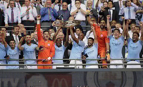 Manchester City players celebrate with the trophy after they won the Community Shield soccer match between Chelsea and Manchester City at Wembley, London, Sunday, Aug. 5, 2018. | AP
