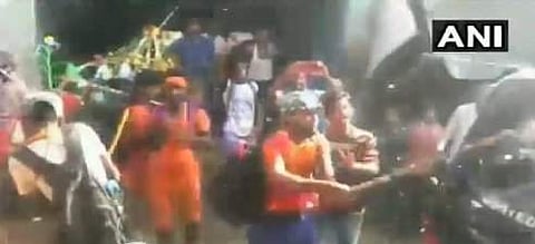 A screengrab from the showing Kanwariyas vandalising a car in Delhi on 8 August 2018. (Photo | ANI)