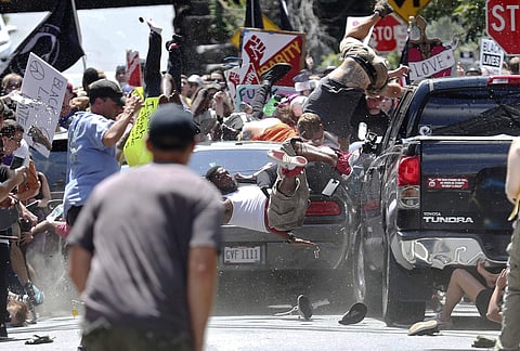 People fly into the air as a vehicle drives into a group of protesters demonstrating against a white nationalist rally in Charlottesville, Va., Saturday, Aug. 12, 2017. (Photo | AP)