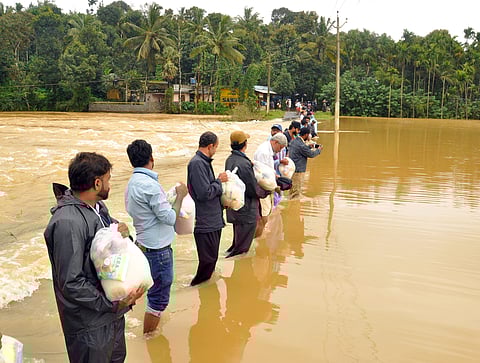 Relief workers taking food and necessities to the tribals stuck due to heavy rain and water logging here in Wayanad. (Photo |A Sanesh /EPS)