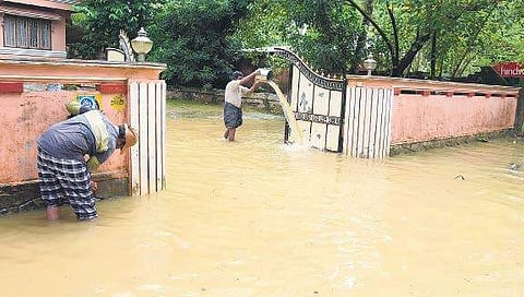 Residents cleaning their houses which were flooded in the rain at Palakkadavu in Neyyatinkara. Water levels are yet to recede in the region which was inundated on Tuesday evening  B P Deepu
