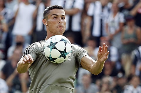 Cristiano Ronaldo controls the ball during a friendly match between the Juventus A and B teams, in Villar Perosa, northern Italy. The eyes of the footballing world will be on Verona where Cristiano Ronaldo is expected to make his Serie A debut when Chievo