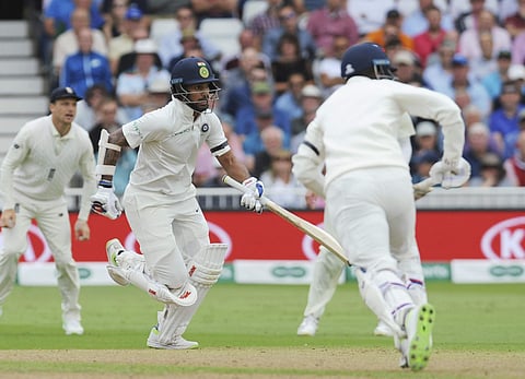 India's Shikhar Dhawan, left, and Lokesh Rahul take a run during the first day of the third cricket test match between England and India at Trent Bridge in Nottingham, England. They can be seen with black armbands. (Photo | AP)