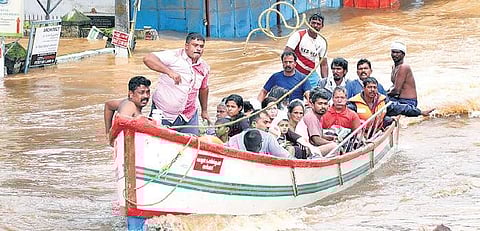 Fishermen from coastal regions of Ernakulam assist rescue operations in small fishing boats at Thottumugham near Aluva on Friday | melton antony