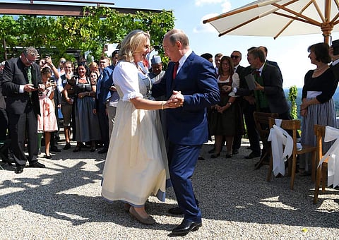 Russian President Vladimir Putin, right, congratulates Austrian Foreign Minister Karin Kneissl as he attends the wedding of Kneissl with with Austrian businessman Wolfgang Meilinger in Gamlitz, southern Austria. (Photo | AP)