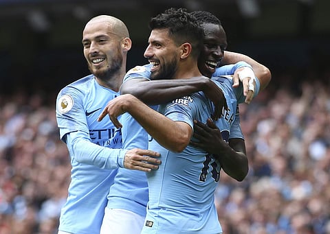 Manchester City's Sergio Aguero celebrates with David Silva and Benjamin Mendy | AP