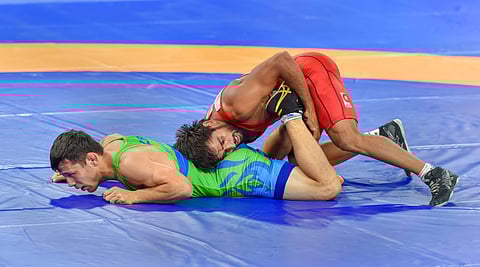 India's wrestler Bajrang Punia with Uzbekistan's Khasanov Sirojiddin in the men's freestyle wrestling 65kg qualification round at the Asian Games 2018 in Jakarta on Sunday August 19 2018. (Photo | PTI)