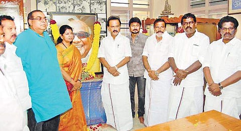 MK Stalin, MP Kanimozhi and others paying respect to M Karunanidhi’s portrait at his ancestral house in Thirukkuvalai on Saturday | Express