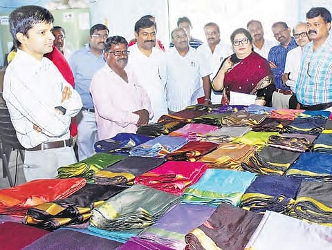 Handloom and Textiles director Shailaja Ramaiyer inspects Bathukamma sarees at a yard in Sircilla on Saturday | EXPRESS