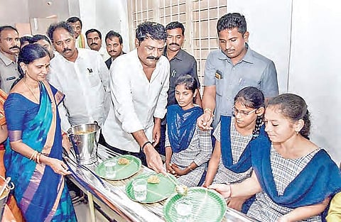 Human Resources Development Minister Ganta Srinivasa Rao serves food to a student after launching the midday meal scheme at the Government Women’s College in Visakhapatnam on Wednesday | Express