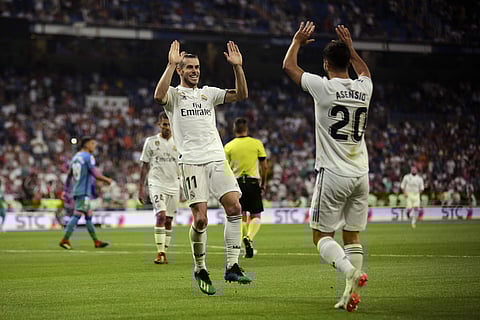 Real Madrid's Gareth Bale, left, celebrates with teammate Marco Asensio after scoring their side's second goal against Getafe during a Spanish La Liga soccer match at the Santiago Bernabeu stadium in Madrid, Sunday, Aug. 19, 2018. | AP